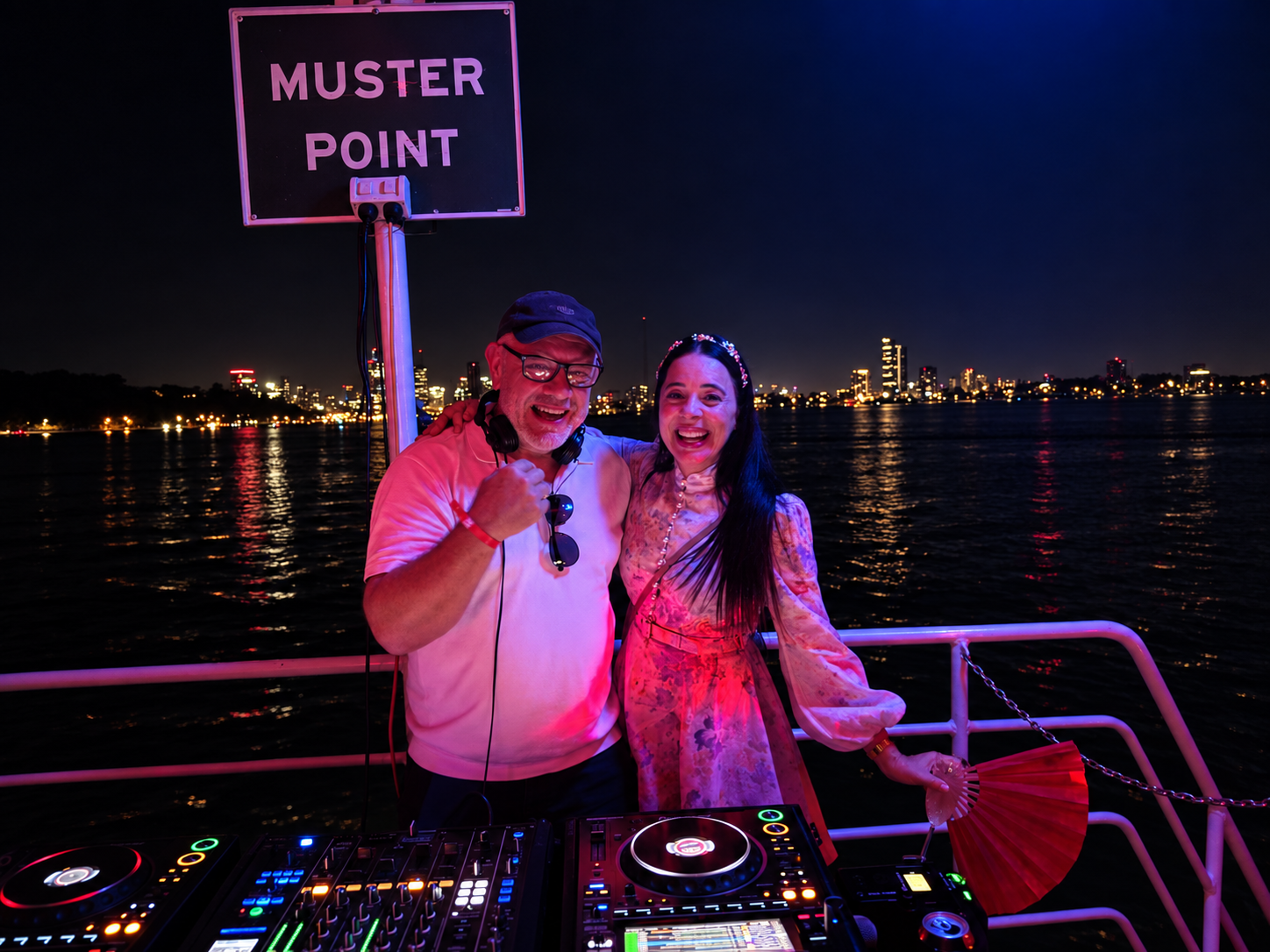 JoNisha with a fellow DJ performing at a nighttime waterfront event in Perth