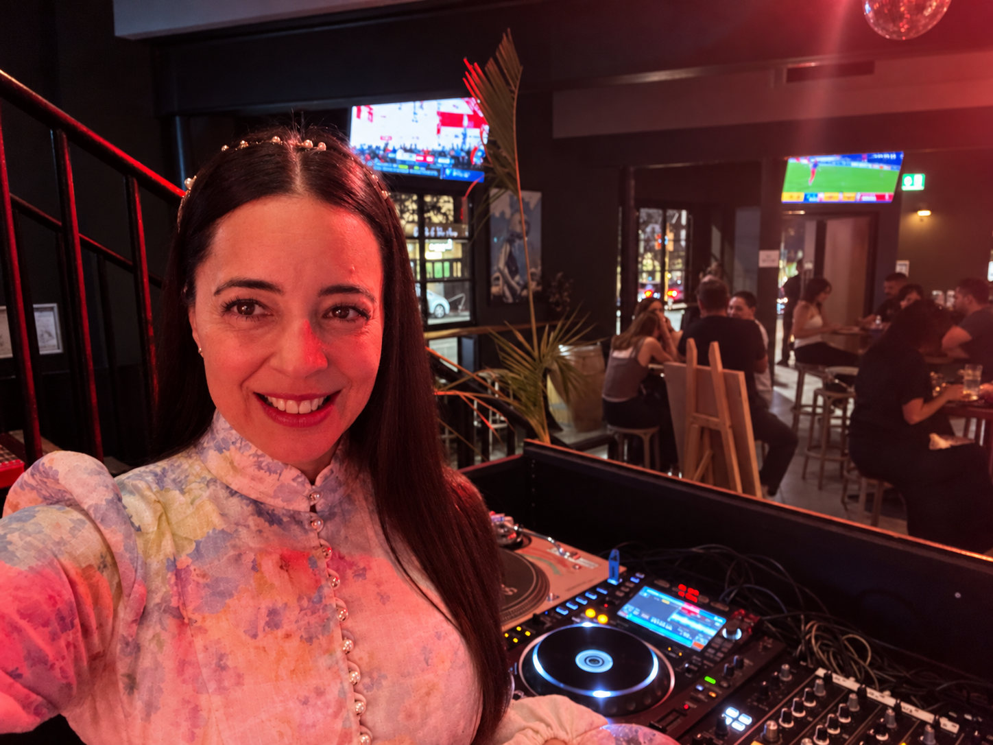 JoNisha behind the DJ decks at a lively Perth bar