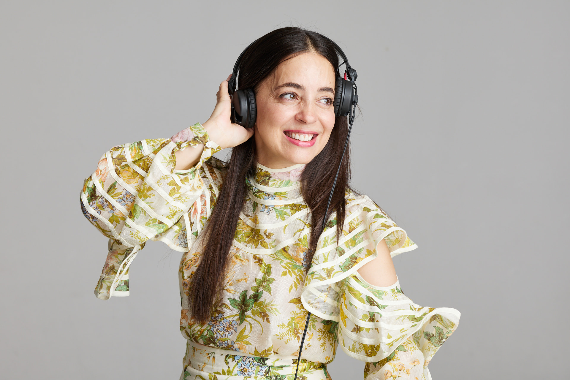 JoNisha wearing headphones in a floral outfit